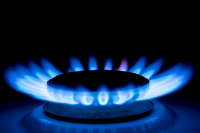Gas burner blue flames on dark black background